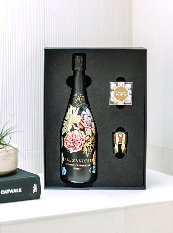 The perfect gift to say "Cheers" for every occasion. Our "Cheers Gift Bundle" includes a bottle of boutique bubbles, a SugarFina candy cube, gold champagne stopper and tasting notes.