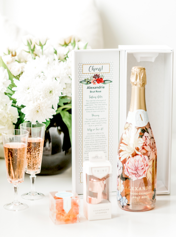 The perfect gift to say "Cheers!" for every occasion. Our "Cheers Gift Bundle" includes a bottle of Alexandrie Sparking Rosé in our celebratory "Cheers" gift box, a SugarFina candy cube, and rose gold champagne stopper.