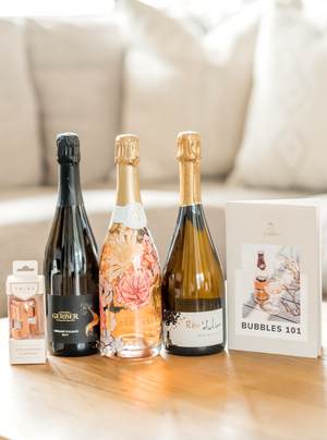 Our Bubbles 101 gift set is the perfect gift for any occasion for any bubbles lover! This set includes a selection of three small-batch, boutique sparkling wines, a rose gold champagne stopper and our Bubbles 101 Booklet.  