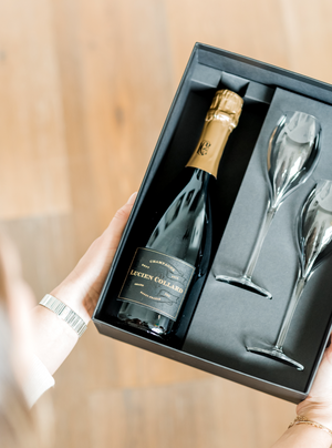 The perfect gift to say "welcome home!" Packaged in an elegant gift box, this set includes one bottle of Lucien Collard Grand Cru 2014 Champagne, two tulip-style crystal toasting flutes, and one rose gold champagne stopper.